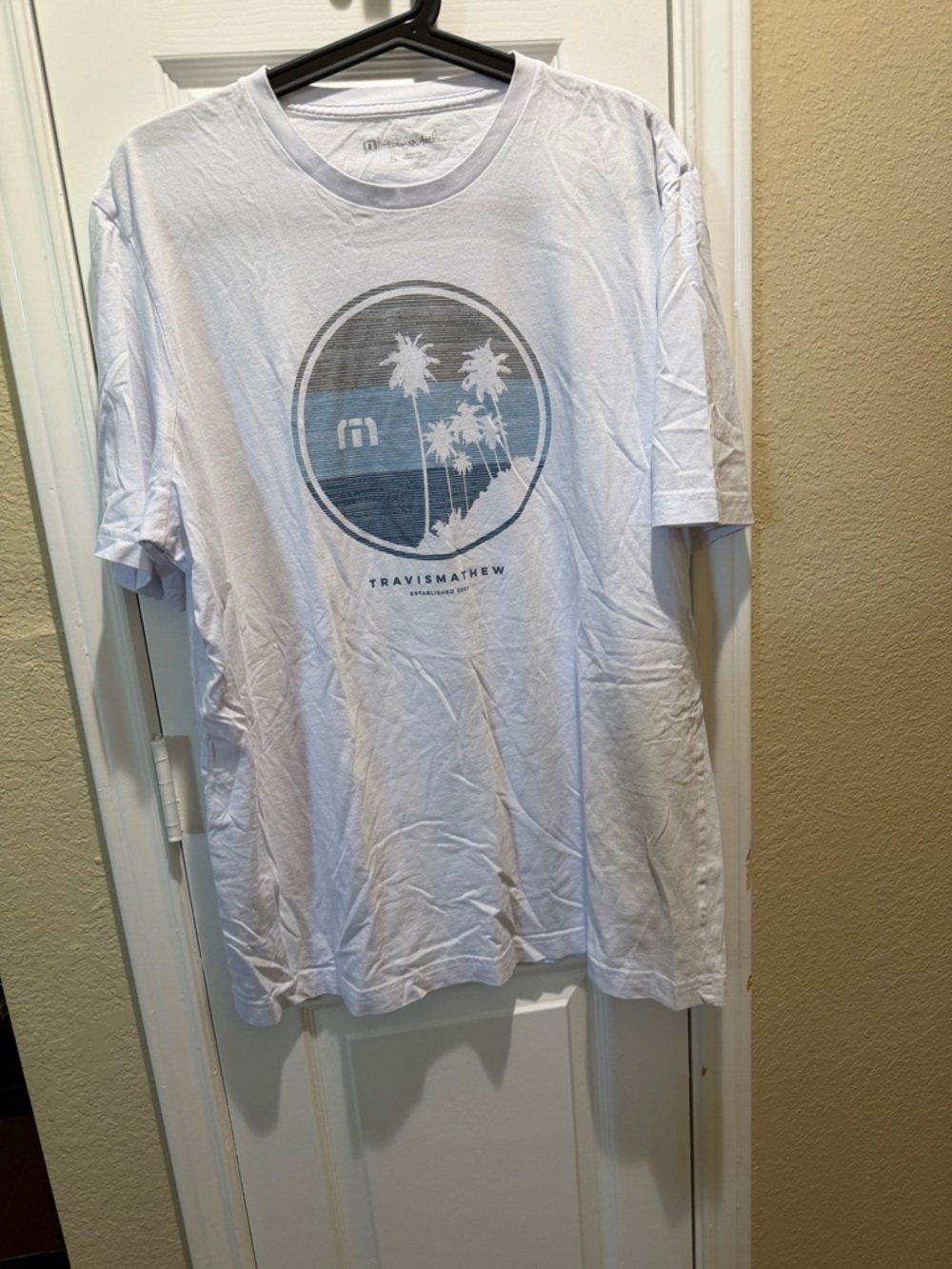 Travis Mathew White Short Sleeve Graphic Tee with Blue Palm Circle